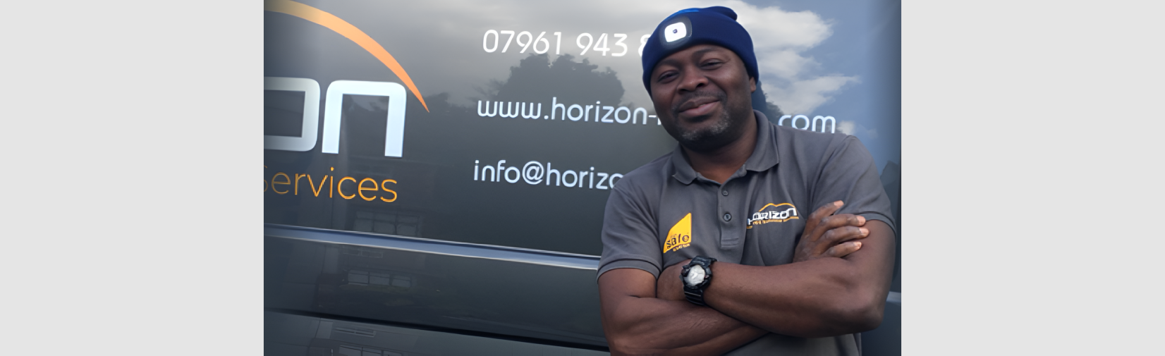 A professional technician from Horizon Services performs heating and plumbing maintenance in a residential setting