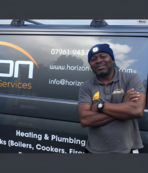 A professional technician from Horizon Services performs heating and plumbing maintenance in a residential setting