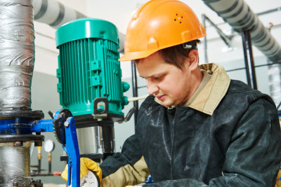 man checking somthing in the boiler room