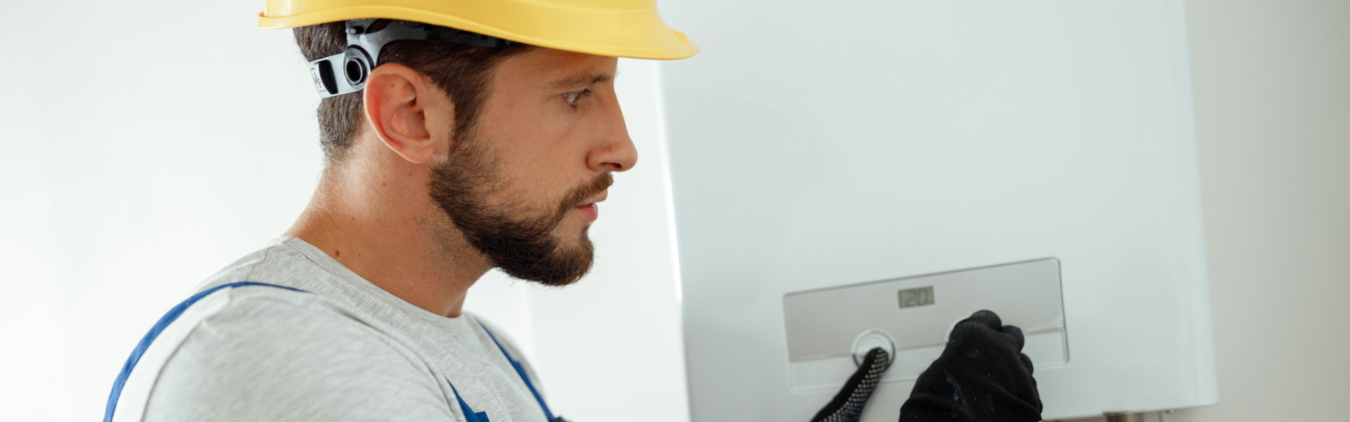 man adjusting the temp of the boiler