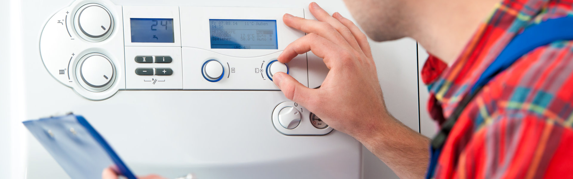 man adjusting the temp of the boiler