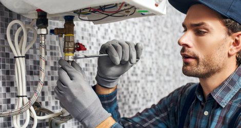 man fixing the boiler pipe